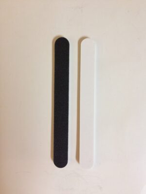 A pair of black and white nail files on top of each other.