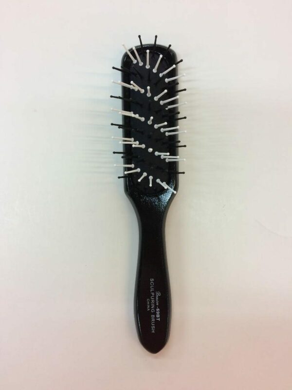 A black brush with white and silver pins on it.
