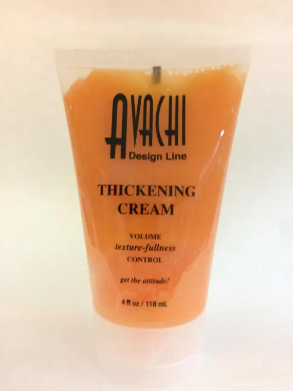 A plastic cup with orange juice and black writing.