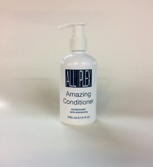 A bottle of conditioner sitting on top of a counter.