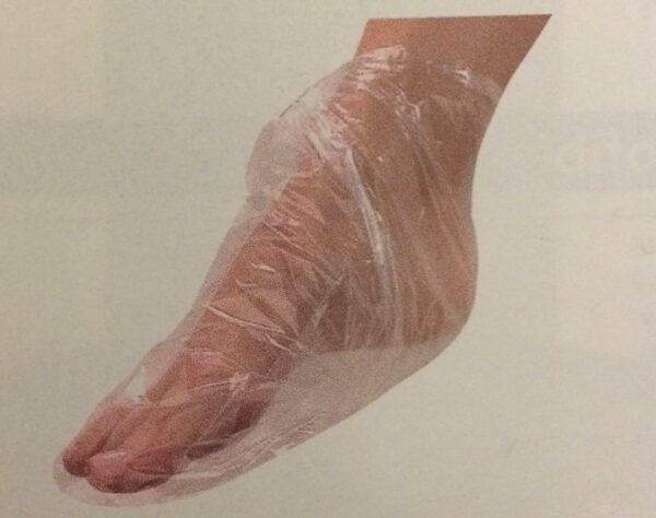 A person with their foot wrapped in plastic.