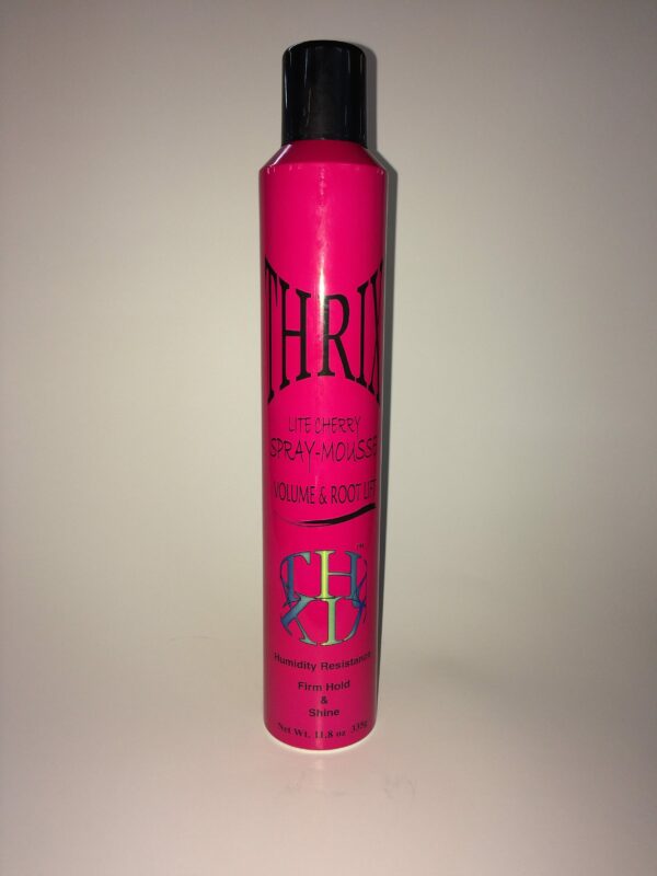 A pink bottle of hair spray on top of a table.