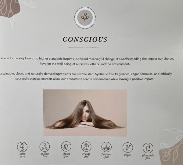 A woman with long hair is sitting in front of the words conscious.